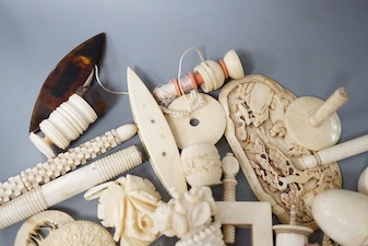 A mixed collection of antique ivory to include a late 18th / early 19th century Chinese carved cartouche, a simulated jockey cap tape measure, etc